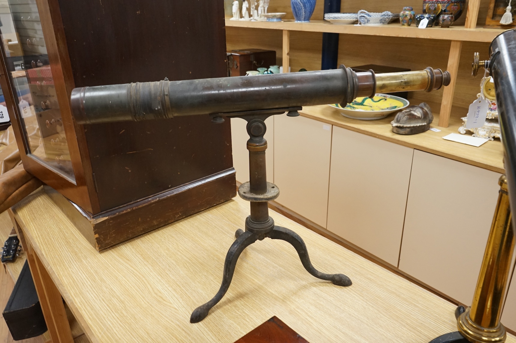 An early 20th century brass two draw telescope on tabletop tripod stand, with engraved dedication; ‘ Computed and Presented by J.W. Gifford. F.R.A.S. Chard 1917’, 73cm long, 48cm high on stand.